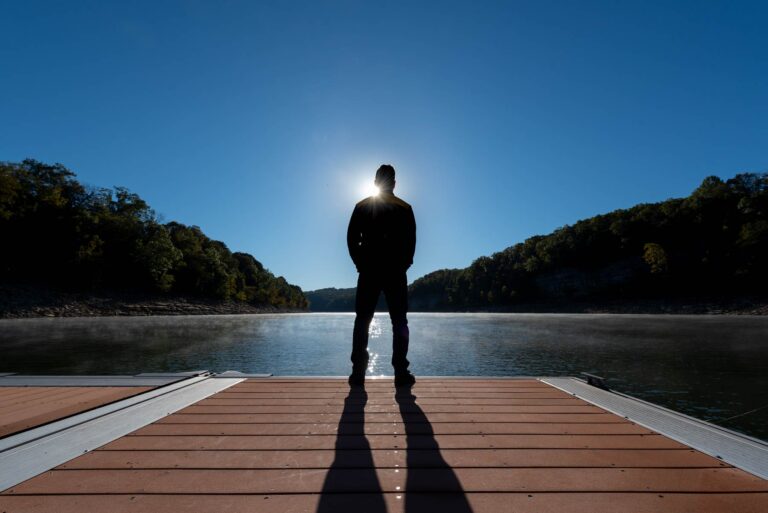 Man standing on the private dock at the Villas at Woodson Bend