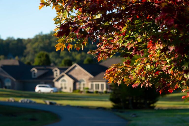 Fall leaves and house at the Villas at Woodson Bend